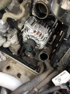 Internal view of an engine bay showing a newly replaced alternator.