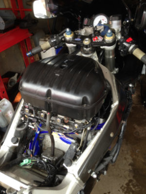 Cover removed from a motorbike showing its internal parts.