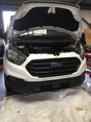 Van repair is complete. Showing a brand-new replaced front bumper.