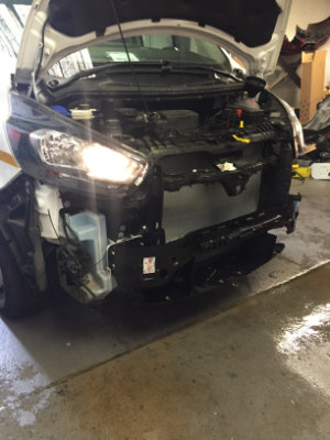 Van's front bumper removed revealing the radiator.